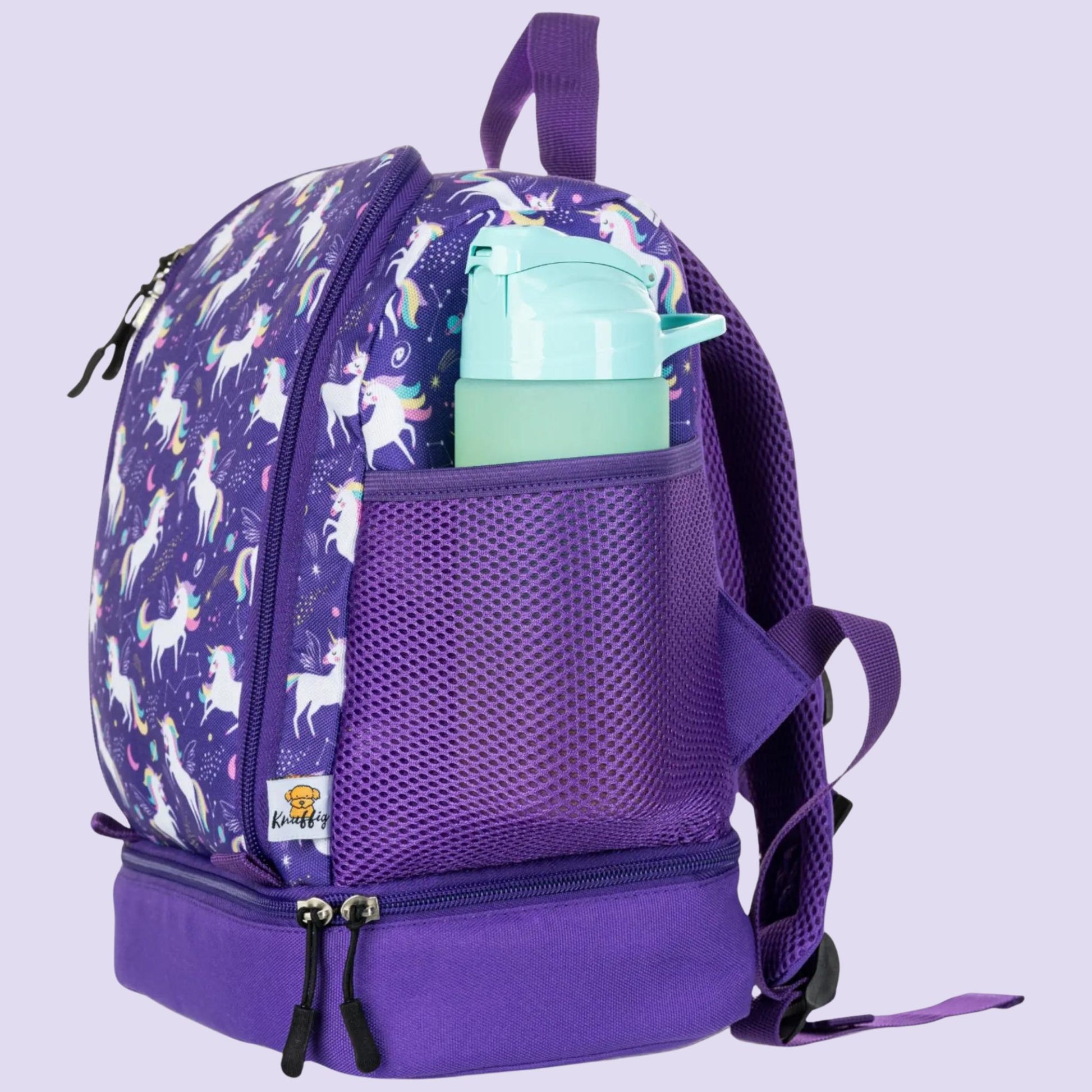 Detailansicht der rechten Seite des lila Einhorn-Kinderrucksacks. Im Fokus steht das elastische, dunkellila Netzfach, das eine Trinkflasche sicher umschließt. Der Hintergrund zeigt den hochwertigen, lilafarbenen Stoff mit dezentem Sternen-Print. Die Aufnahme verdeutlicht, wie einfach Kinder ihre Erfrischung griffbereit haben, ohne das Hauptfach öffnen zu müssen, und unterstreicht die praktische Organisation für den Kindergartenalltag.