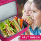 Nahaufnahme des isolierten unteren Fachs der pinken Kinder-Umhängetasche; perfekt geeignet, um eine Lunchbox mit Snacks oder Sandwiches unterwegs kühl und frisch zu halten.